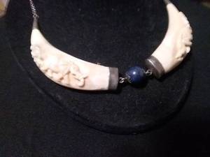 lot 276 image: Double TuskBone Carved Necklace with Sterling Silver Caps and Lapis Lazuli Bead.