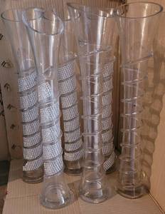 lot 18 image: LOT OF 6 GLASS VASES WITH HOURGLASS BODY AND SLANT TOP AND SWIRL DESIGN IN STYLECOLORCONDITION SHOWN. EACH 20H x 4.75 DIA. (YOUR BID X 6)