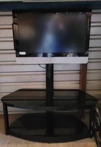 lot 121 image: TV CONSOLE WITH MOUNTED VIZIO VX32L HDTV IN STYLECOLORCONDITION SHOWN. APPROX. 44 W x 20.5 D x 19 H (CABINET PART), 56 H WITH MOUNT AND MONITOR.