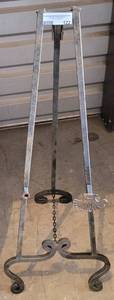 lot 122 image: WROUGHT IRON STYLE EASEL IN CONDITION SHOWN. APPROX. 14 W x 35.5 H x 17 D.