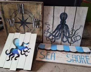 lot 300 image: LOT OF 4 MARINENAUTICAL THEME WALL ART IN STYLESCOLORSCONDITION SHOWN. SIZES VARY FROM 24 W x 10.25 H TO 20 W x 20 H. (YOUR BID X 4)