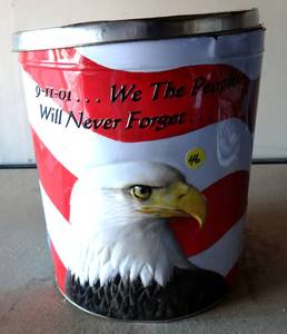 lot 46 image: Large Tin Metal Popcorn Can dedicated to Sept 11th filled with various toys