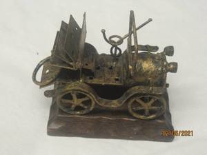 lot 223 image: ANTIQUE METAL CAR ON WOOD PLAQUE