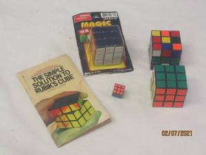 lot 244 image: VINTAGE RUBIK CUBES AND THE SIMPLE SOLUTION TO RUBIKS GUIDE BOOK