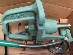 lot 133 image: RCBS Rock CHUNKER PRESS green in original box,  Metal gray tool box ,empty BRASS CASES L C 65 shells,