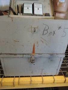 lot 134 image: 2 metal boxes 9x18x12   with  HERECULES Rifle powder,  2 cans of smokeless powder(DUPONT 4320 & 4350) and gun cleaning wire brushes