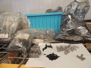 lot 250 image: Blue tote full of springs, star head screws drill bit heads and nuts