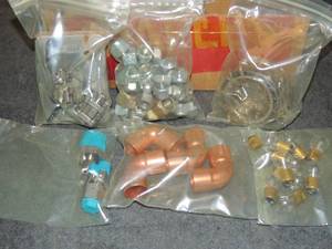 lot 726 image: Misc. lot swag lot  shut off valves mini light bulbs, nuts and bolts, and copper elbow fittings