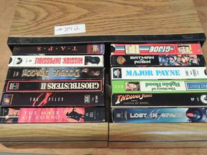 lot 842 image: Movie VHS holder full of movies Major pain, Double Dragon, Robin Hood, Lost in space, Indiana jones