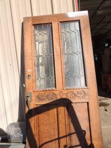 lot 1014 image: WOOD FRONT DOOR  HAS LEADED GLASS INSERTS , 36 X 80  HAS OVERSPRAY OF PAINT ON ONE SIDE