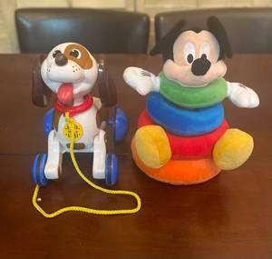 lot 201 image: A Tomy Pull behind rolling barking dog toy and Mickey Plush stacking toy