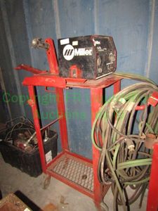 lot 174 image: Miller R-115 wire feeder on metal cart