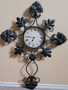lot 50 image: METAL WALL DECOR CROSS WITH CLOCK IN STYLE, COLOR, AND CONDITION SHOWN. APPROX. 26 W x 36 H.