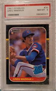 lot 60 image: 1987 DONRUSS GREG MADDUX #36 RATED ROOKIE NM-MT 8 BASEBALL CARD IN PROTECTIVE HOLDER AS SHOWN.