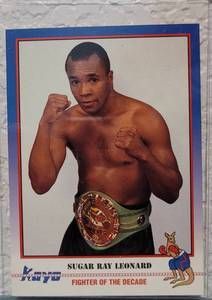 lot 63 image: 1991 KAYO CARDS #156 SUGAR RAY LEONARD FIGHTER OF THE DECADE BOXING CARD IN PROTECTIVE SLEEVE AS SHOWN.