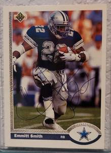 lot 66 image: SIGNED 1991 UPPER DECK #172 EMMITT SMITH FOOTBALL CARD IN PROTECTIVE SLEEVE AS SHOWN. SEE PICTURES