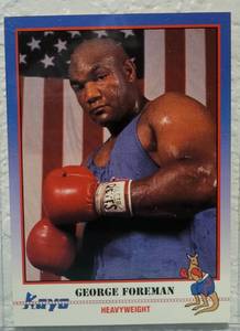 lot 68 image: 1991 KAYO CARDS #099 GEORGE FOREMAN BOXING CARD IN PROTECTIVE SLEEVE AS SHOWN.