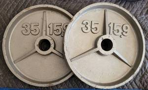 lot 144 image: LOT OF 2 BARBELL WEIGHT PLATES AS SHOWN. 35 LBS EACH. (YOUR BID X 2)