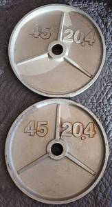 lot 145 image: LOT OF 2 BARBELL WEIGHT PLATES AS SHOWN. 45 LBS EACH. (YOUR BID X 2)