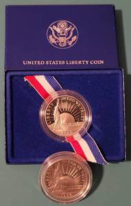 lot 205 image: LOT OF 2 1986 LIBERTY HALF DOLLAR COINS AS SHOWN. ONE HAS A DISPLAYSTORAGE BOX. (YOUR BID X 2)