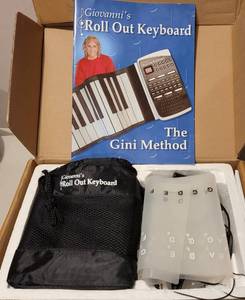 lot 249 image: GIOVANNIS ROLL OUT KEYBOARD THE GINI METHOD IN BOX AS SHOWN.