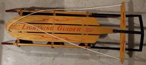 lot 281 image: VINTAGE STANDARD NOVELTY WORKS DUNCANNON, PA LIGHTING GUIDER SLED #123 12 IN EXCELLENT CONDITION FOR ITS AGE AS SHOWN. GREAT GRAPHICS APPROX. 52 LONG AND HANDLE 22 ACROSS. CHECK IT OUT