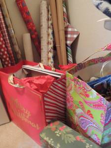 lot 52 image: Christmas lot- paper, bags, tins, ribbons etc.