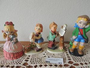 lot 63 image: 1973 pink girl 6 tall 1973 Lil Boy 7 tall, Girl holding rabbit 5, boy playing violin 5 red bow tie is broken