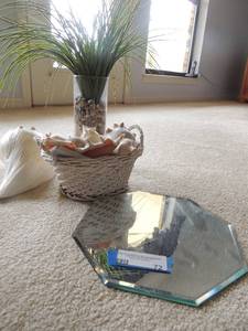 lot 72 image: Octagon mirror 10 diameter white 9 seashell, glass vase with rocks and green grass, plastic white wicker basket full of seashells