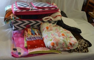 lot 172 image: Kids Rolling Suitcase with variety of Kids Throw Fleece Blankets