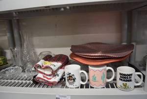 lot 36 image: Glass Crystal Cake Plate, Decanter and More, Coffee Mugs, Round Place Mats and Apron