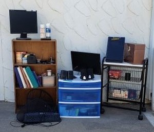 lot 124 image: Small Bookshelf, Asus Monitor, Samsung Monitor, Office Supplies as shown, Computer Keyboards, Rolling Cart with Basket Storage