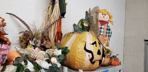 lot 7 image: Fall and Outdoor Decorations Flower Arrangements, Metal decorations and Cloth Scarecrows on Yard Stake