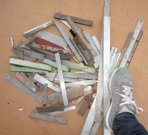 lot 243 image: Assorted machining shims as shown. (Human foot not included, for size reference only )