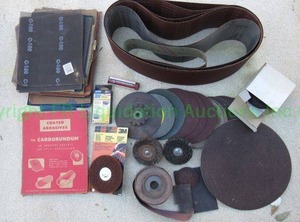 lot 209 image: Sanding belts and wheels and more as shown