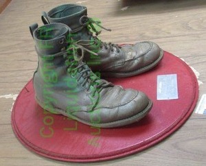 lot 96 image: Novelty brass colored work boots mounted on wall placard