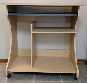 lot 12 image: COMPUTER DESK WITH PULL OUT KEYBOARD TRAY AND PRINTER SLOT WITH WHEELS IN STYLE, COLOR, AND CONDITION SHOWN. 32.5 W x 19.25 D x 31.5 H