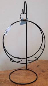 lot 28 image: METAL HOLDER WITH STAND IN STYLE, COLOR, AND CONDITION SHOWN.
