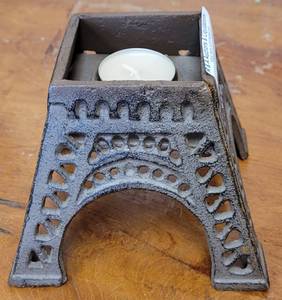 lot 30 image: CAST IRON VOTIVE HOLDER IN STYLE, COLOR, AND CONDITION SHOWN.