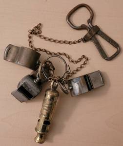 lot 111 image: VINTAGE WHISTLES INCLUDING THE ACME THUNDERER ENGLAND, THE METROPOLITAN J. HUDSON CO., MILITARY AND MORE WITH VINTAGE COCA-COLA BOTTLE OPENER AS SHOWN.