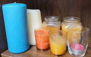 lot 140 image: LOT OF CANDLES AND CANDLE HOLDERS AS SHOWN.
