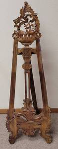 lot 169 image: VINTAGE WOOD EASEL WITH INTRICATE CARVED DESIGN IN STYLE, COLOR, AND CONDITION SHOWN. 14 W x 40.5 H