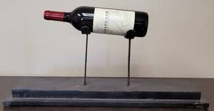 lot 173 image: METAL WINE BOTTLE STAND  HOLDER IN STYLE, COLOR, AND CONDITION SHOWN. BOTTLE NOT INCLUDED. 23.25 W x 6 D x 9.25 H