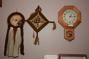 lot 37 image: Hanging wall clock & Native American inspired wall decor
