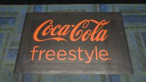 lot 35 image: Authentic Coca-Cola Freestyle Rubber Floor Mat, 3 x 5