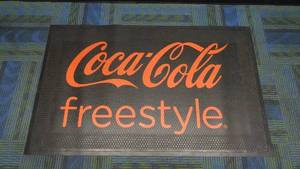 lot 36 image: Authentic Coca-Cola Freestyle Rubber Floor Mat, 3 x 5