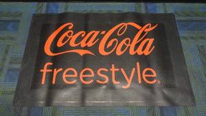 lot 39 image: Authentic Coca-Cola Freestyle Rubber Floor Mat, 3 x 5