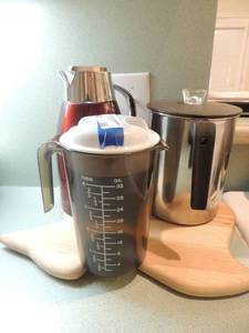 lot 66 image: Red Starbucks coffee pot black and stainless Steele water pitcher and Texas shaped wooden cutting board