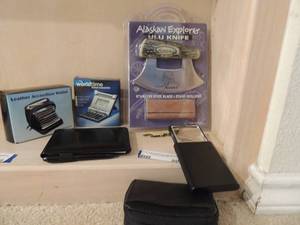 lot 80 image: Alaskan explorer ULU knife stainless steel blade with stand, cork screw knife leather accordion wallet NIB world time travel calculator NIB