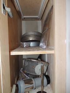 lot 132 image: 4 cake pans, oven racks x 2, wooden cutting board, strainer and more